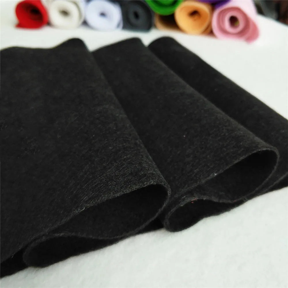 A stack of black felt fabric sheets for DIY crafts and sewing projects.