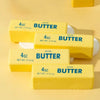 Three yellow butter sticks labeled 4oz salted butter are displayed on a light background.