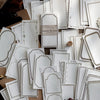A collection of vintage scrapbooking paper sheets in off-white and cream tones for journaling and crafts.