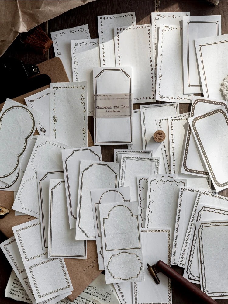 A collection of vintage scrapbooking paper sheets in off-white and cream tones for journaling and crafts.