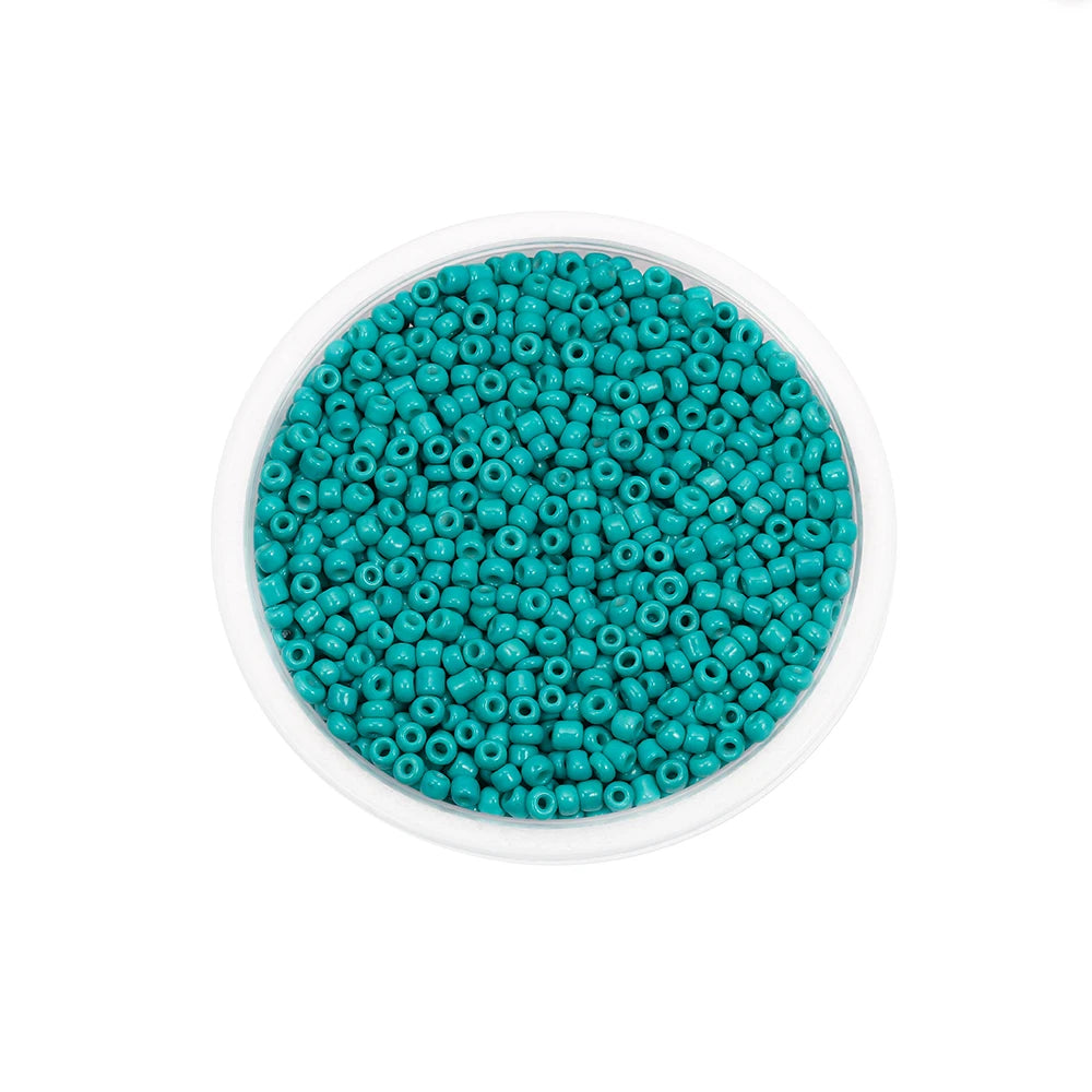A clear container filled with small, round, teal glass seed beads for jewelry making.