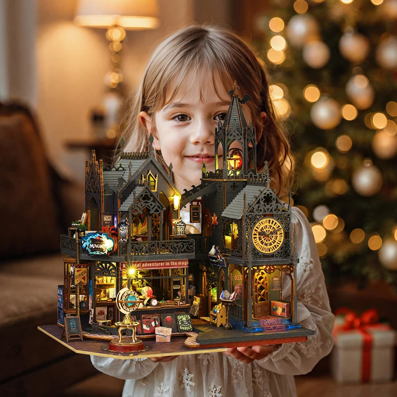 A young girl holds a detailed wooden 3D puzzle dollhouse kit of a magical city castle.