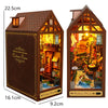 A wooden fairy tale town diorama kit featuring miniature furniture and a pitched roof.