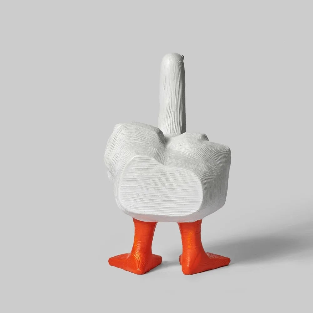 A white resin figurine shaped like a goose with a middle finger gesture.