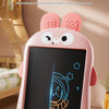 A pink LCD drawing board for kids is shown with a hand writing on the screen in a bright indoor setting.