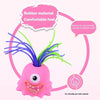 Pink rubber monster toy with purple and green hair used for stress relief