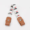 White canvas belt with black mustache and heart designs featuring elastic stretch.