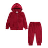 A maroon kids' velvet tracksuit set featuring a hooded zipper jacket and matching pants.
