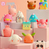A collection of colorful geometric monster mini bean blind box vinyl figures displayed on pink and white boxes.