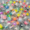 A variety of colorful kawaii mini capsule figures in clear plastic domes are displayed.