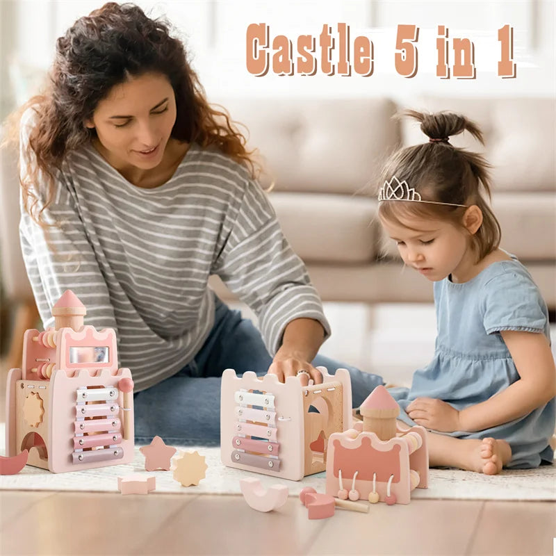 A young girl plays with a wooden rocket stacking toy and shape sorter set.