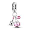 A silver heart charm bead featuring a pink zircon and a diamond-studded bail.