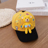 A yellow toddler bear baseball cap with an adjustable strap resting on a wooden surface.