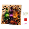 A DIY diamond painting kit featuring three glass bottles decorated with skulls and pearls, set against a Halloween theme.