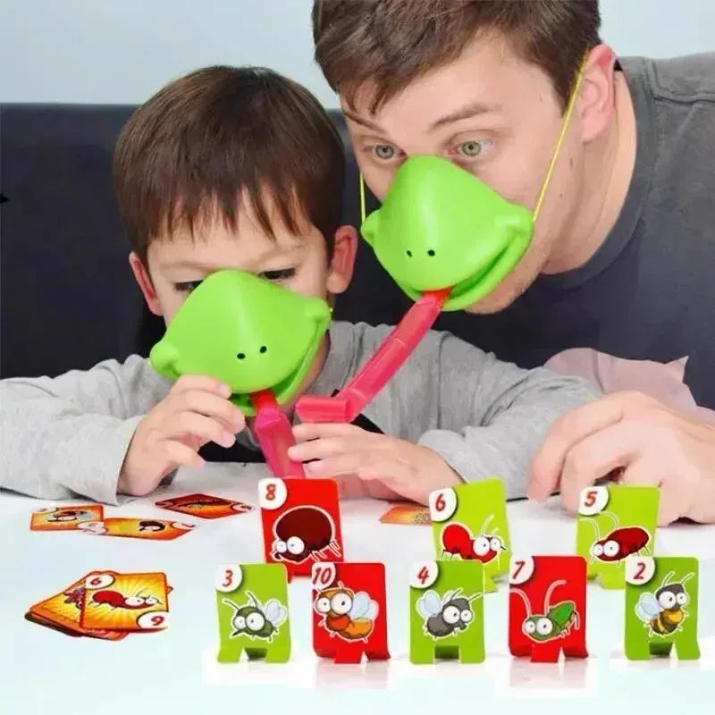 A man is playing a card game with a child, featuring frog-themed cards and masks.