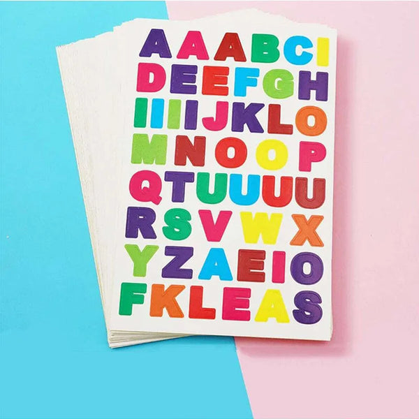 A sheet of colorful alphabet photo stickers arranged in a grid on a pink background.