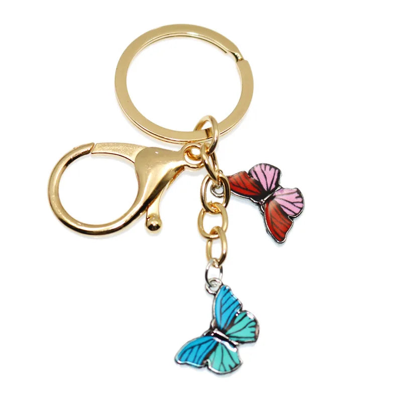 Gold-toned butterfly keychain with a pink and purple enamel butterfly charm