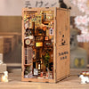 A wooden book nook kit featuring a detailed Japanese alley miniature scene illuminated by LED lights.