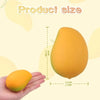 A hand holds a yellow fruit squishy toy, showing its size relative to the palm of the hand.