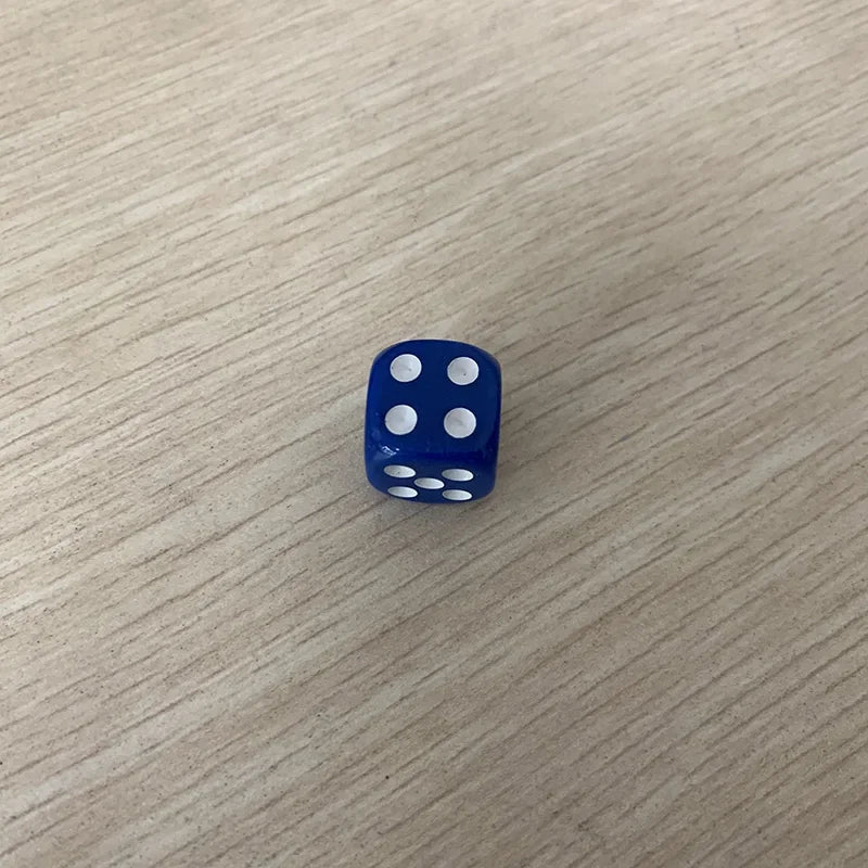 A blue die with five white dots is placed on a light wooden surface.