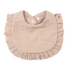 A light beige ruffled muslin cotton baby bib with an adjustable snap closure.