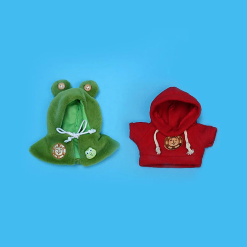 A pair of green and red hooded clothing accessories featuring animal ears and embroidered details.