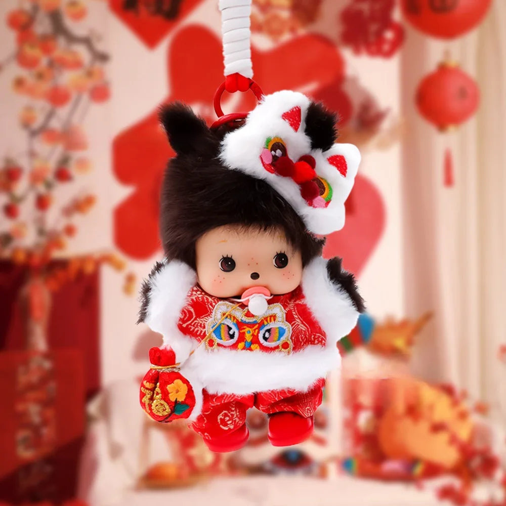 A cute Monchhichi plush keychain with a white and black hat and red outfit hanging from a white strap.