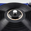 Close-up view of a black aluminum alloy record stabilizer on a turntable platter.