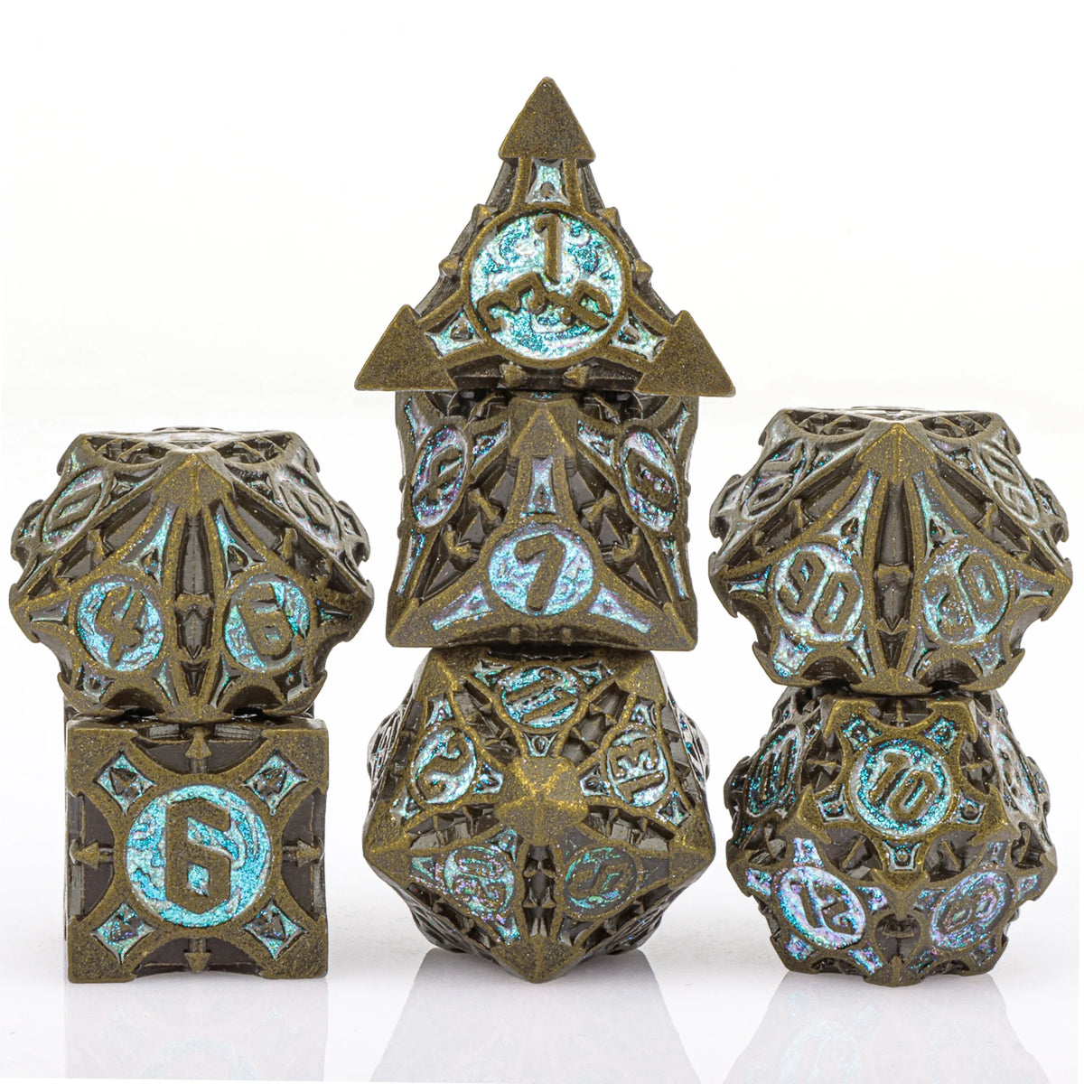 A set of seven metal dice featuring a skull and dragon design in bronze and teal colors.