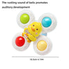 A set of colorful, round bath toys with yellow, red, and blue accents for toddlers.