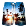 Men's beach swim shorts with a tropical coconut tree print against a sunset water background