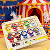 A white magnetic bead puzzle board for kids with various colored beads and a yellow stick, set against a backdrop of a circus