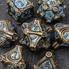A collection of antique bronze and blue metal dice set for tabletop role-playing games