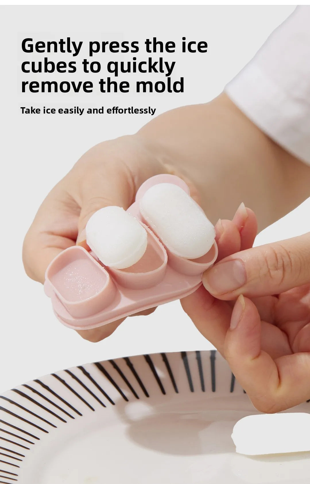 A hand gently presses white silicone ice cubes into a pink mold to remove a mold, demonstrating how to easily take ice.