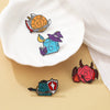 A set of enamel pins featuring dice designs in various colors and styles for Dungeons & Dragons fans