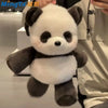 A cute running panda stuffed animal with black and white fur is being held in a close-up shot.