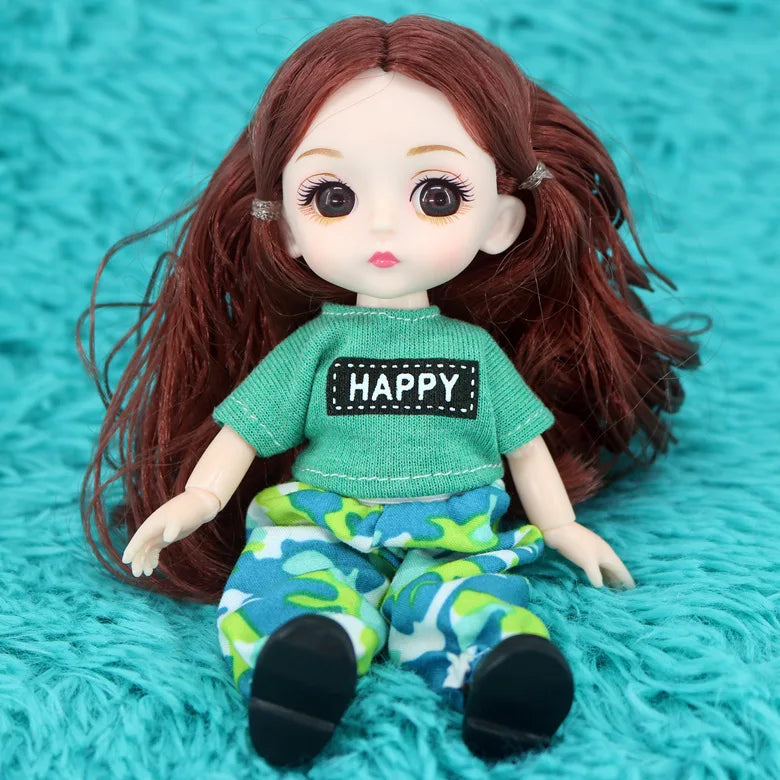 A 16cm articulated BJD princess doll with long red hair wearing a green top and patterned pants.