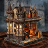 A detailed miniature kit of a wooden magic store cottage with furniture and architectural features.