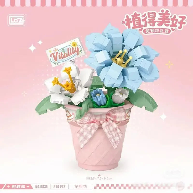 A pink potted flower arrangement made of building blocks featuring blue and white flowers.