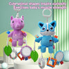 A purple unicorn plush toy is hanging with various colorful rattles and toys for baby muscle exercises.