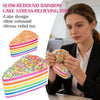 A woman holds a colorful rainbow layer cake stress-relief toy with sprinkles in her hands.