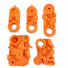 Orange 3D printed fidget toys including a clicker, spinner, and various textured pieces for stress relief