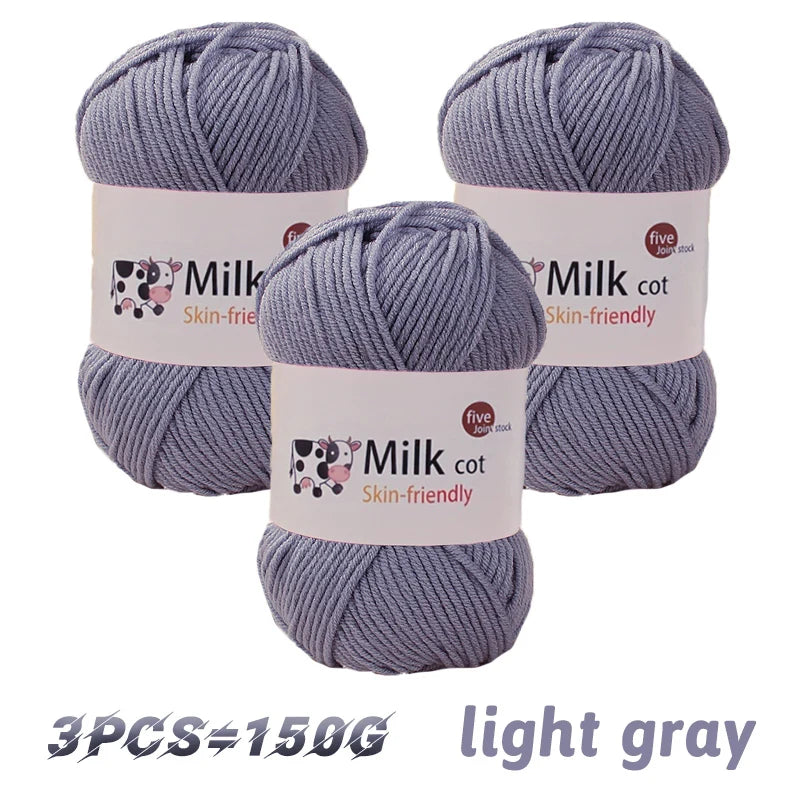 Three skeins of light gray milk cot skin-friendly acrylic yarn for knitting and crochet