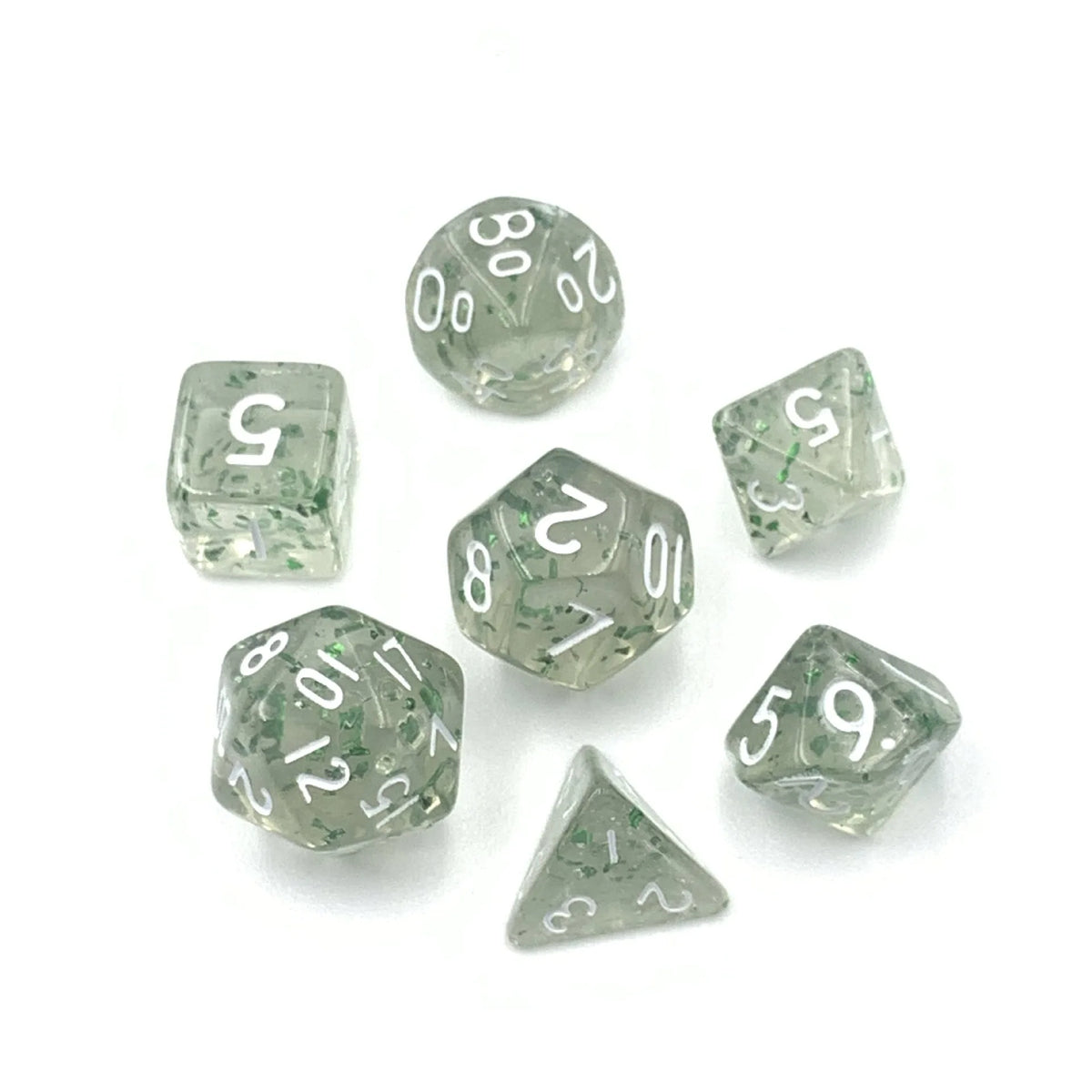 A collection of seven transparent acrylic dice, including d6 and a triangle die, scattered on a white surface.