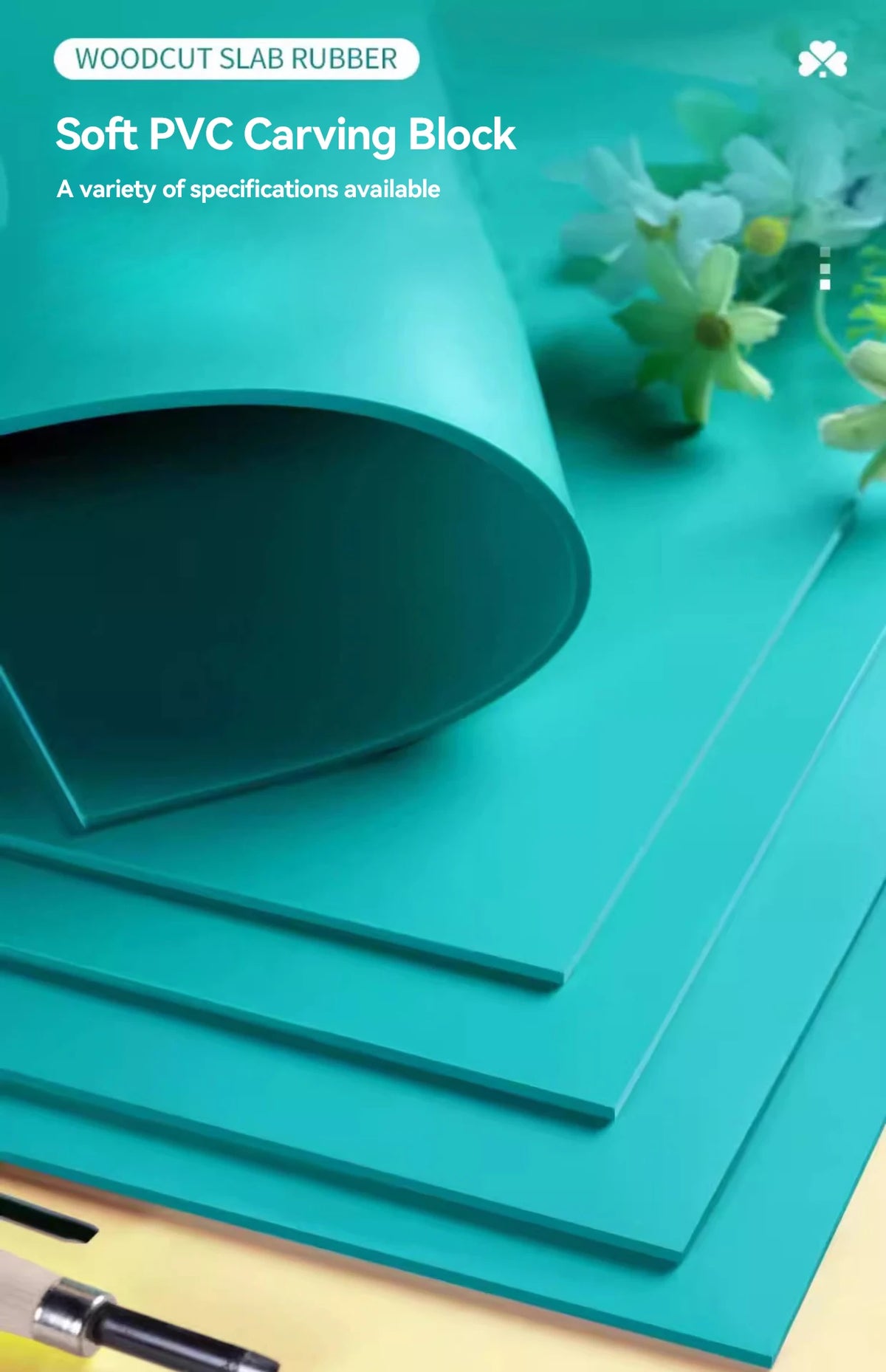 A stack of teal PVC carving blocks and rubber slabs displayed on a light surface.