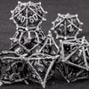 A stack of metallic, geometric dice used for tabletop role-playing games