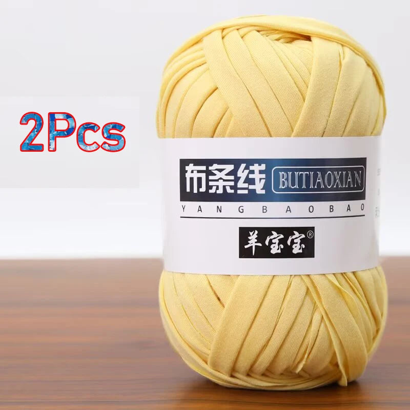 A ball of yellow soft chunky t-shirt yarn for crochet and knitting, packaged as a 2-pack.
