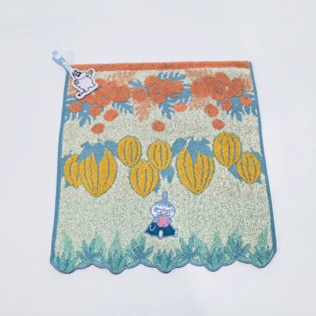 A soft stuffed animal featuring a pygmy hippo design with orange and blue floral accents.