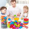 A man and a girl are interacting with a large assortment of colorful plastic toys for sorting and counting.