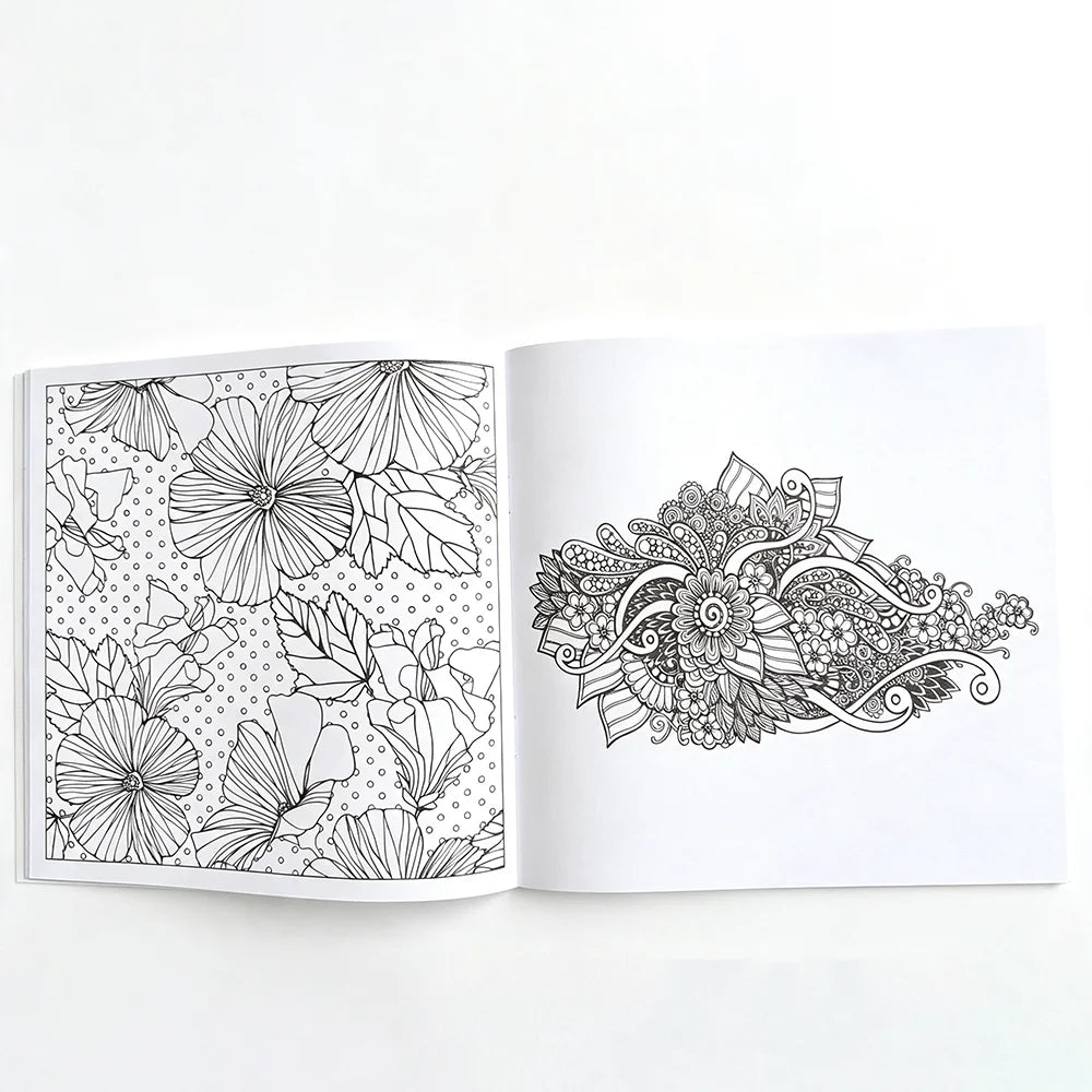 An open page of a mandala coloring book showing intricate floral and leaf patterns for adult stress relief.